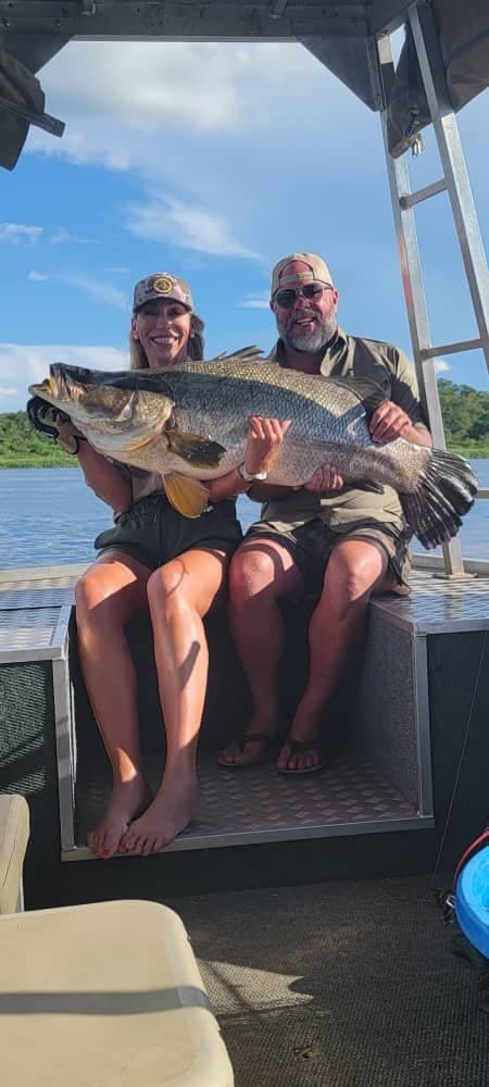 Happy anglers with a giant catch on the water