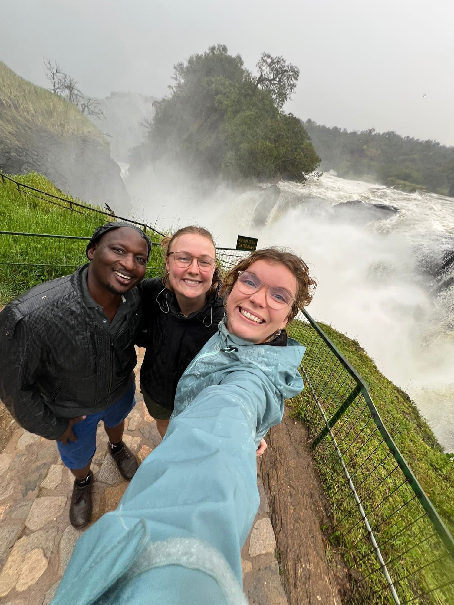 Happy travelers at a powerful waterfall overlook