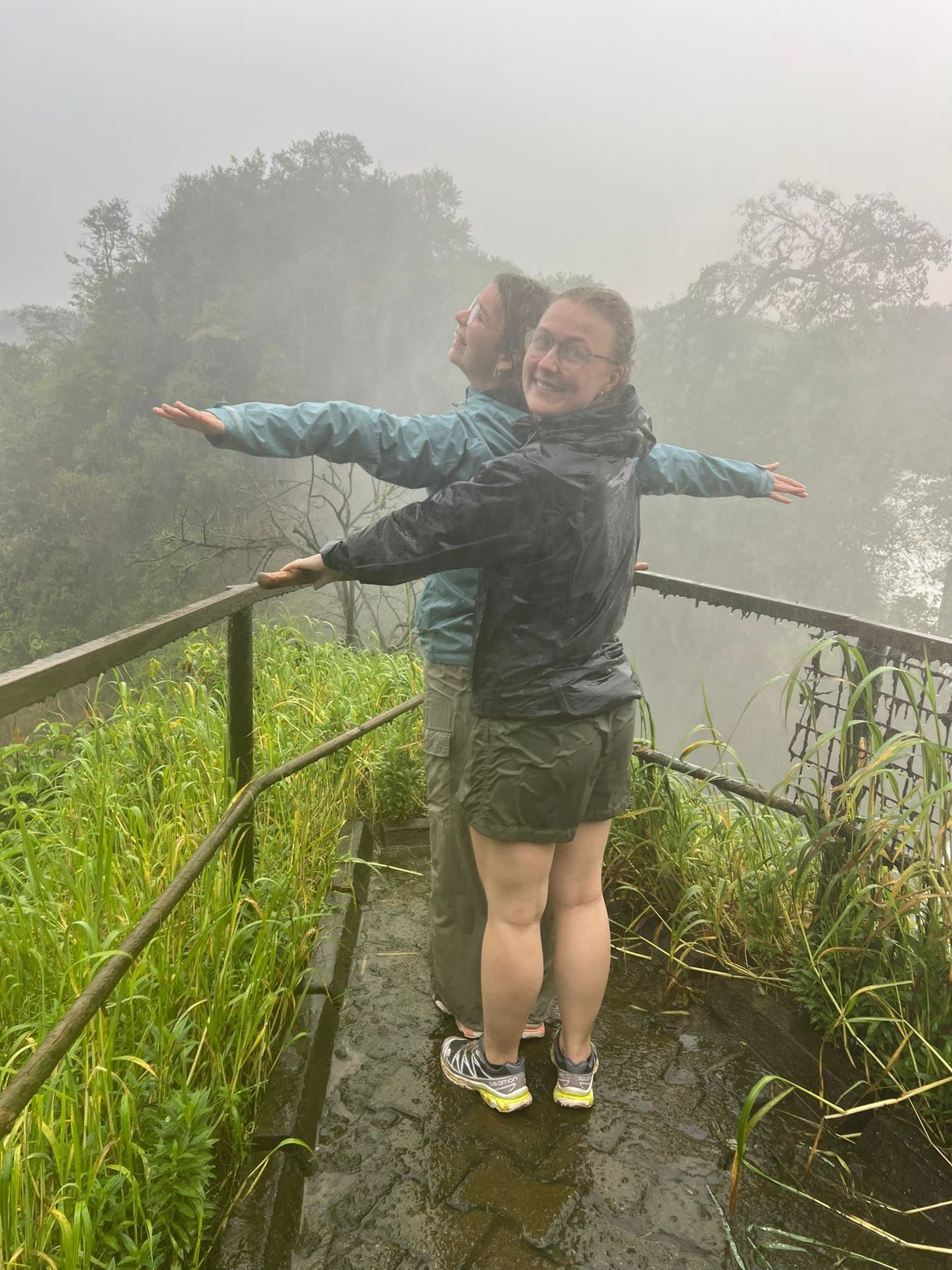 Travelers enjoying the mist at a waterfall lookout