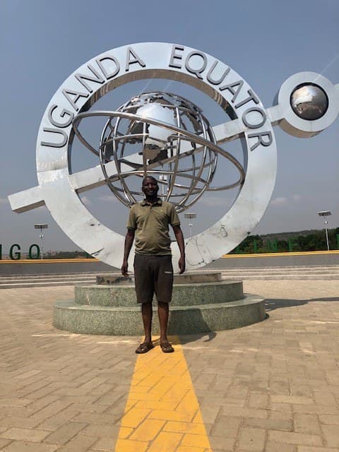 Standing on the Uganda Equator monument line